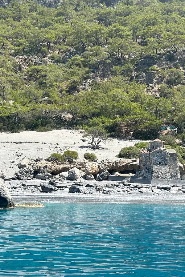Clear blue Aegean Sea meeting the shoreline at Agios Pavlos, a picturesque bay in Crete.